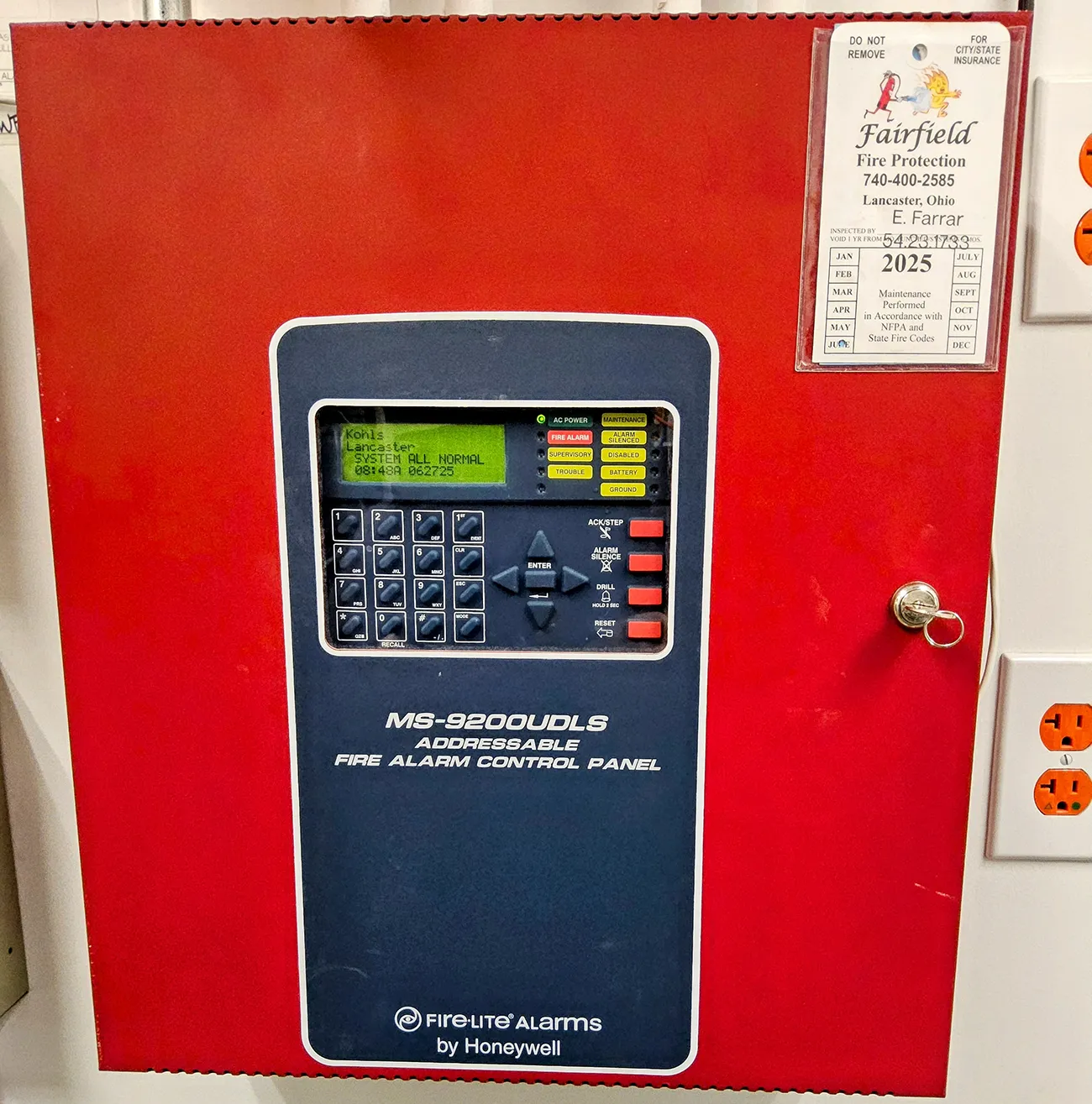 Fire alarm pull station being tested by Fairfield Fire Protection technician