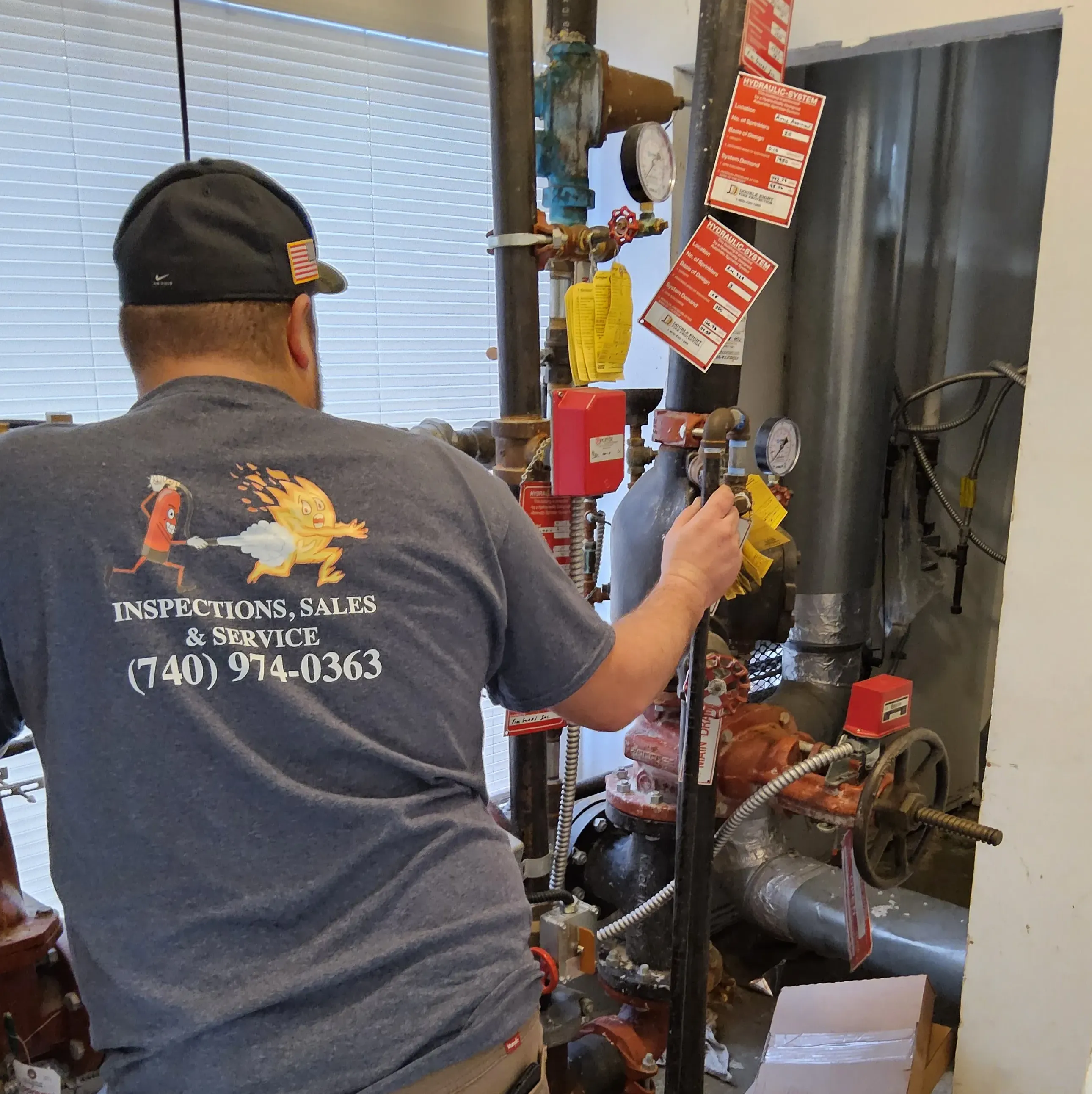 Fairfield Fire Protection technician inspecting a commercial fire sprinkler system in Ohio